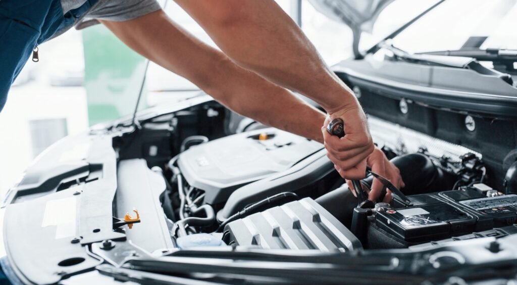 car battery lifespan maintenance tips under the hood, clean car battery terminals to extend car battery lifespan, dead car battery caused by headlights left on, testing car battery voltage with digital multimeter, car battery protected from extreme heat and cold weather